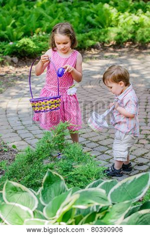 Little Boy And Girl On An Easter Egg Hunt