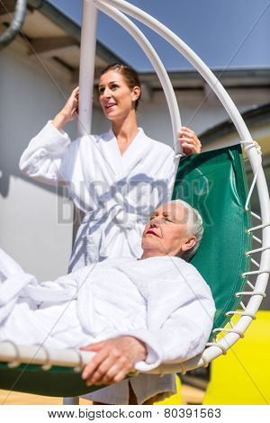 Women realxing on lounger in wellness spa