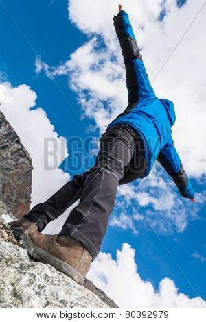 Hiker Catching Balance On Mountain Ridge