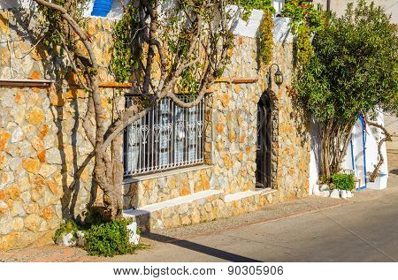 Stone facade and ivy on Greek street, Greece