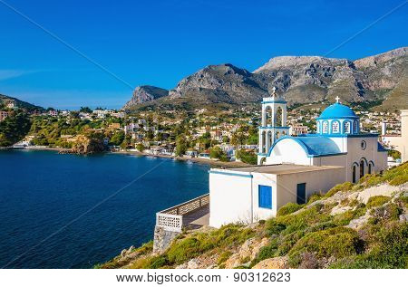 White church with azure blue dome Island, Greece