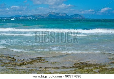 Sunny beach with waves and turquoise ocean