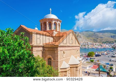 Greek church with red roof and city port