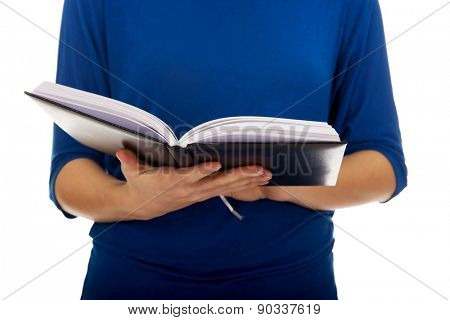 Young caucasian woman reading a book.