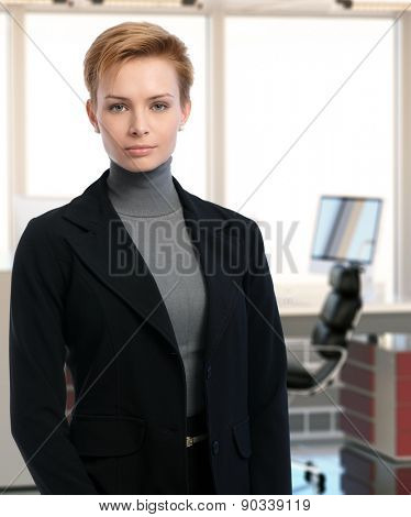 Portrait of serious young businesswoman at office.