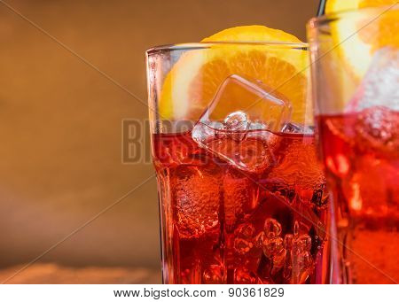Spritz Aperitif Aperol Cocktail With Two Orange Slices And Ice Cubes With Space For Text