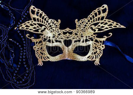 golden carnival mask on dark background