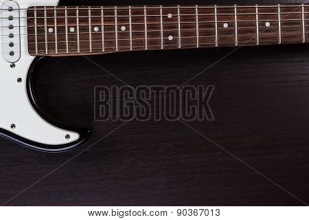 Electric guitar deck on dark background.