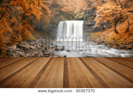 Beautiful Woodland Stream And Waterfall In Autumn Fall With Wooden Planks Floor