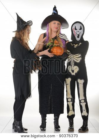 Three women witches posing in scary outfits