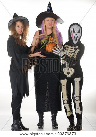 Three women witches posing in scary outfits