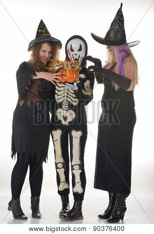 Three women witches posing in scary outfits