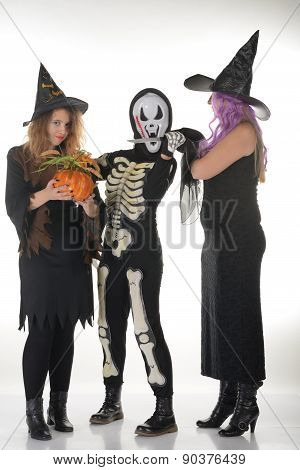 Three women witches posing in scary outfits