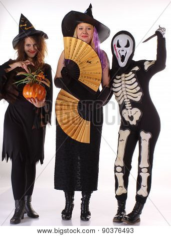 Three women witches posing in scary outfits