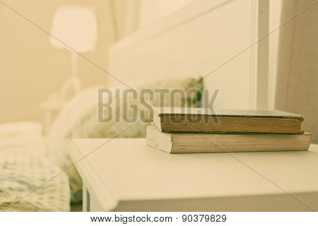 bedroom with books on nightstand - retro style photo