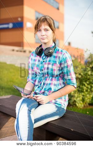 Beautiful young woman student with note pad. Outdoor student.