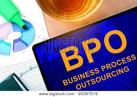 Words  Business Process Outsourcing BPO on the tablet and charts.