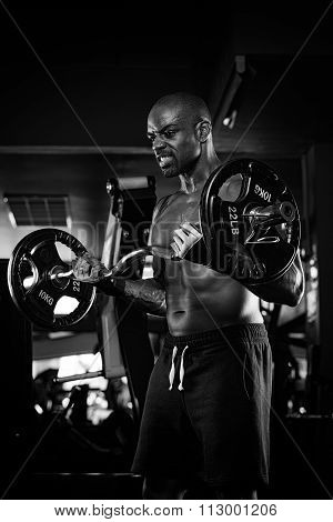 Strong bodybuilder with six pack, perfect abs, shoulders, biceps, triceps and chest