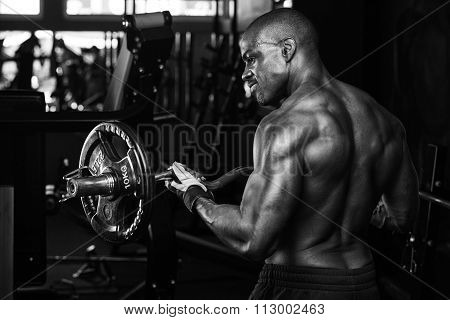 Strong bodybuilder with six pack, perfect abs, shoulders, biceps, triceps and chest