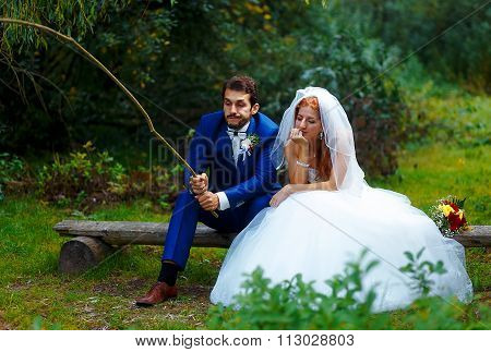 bride and groom fishing together - romantic wedding concept.
