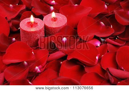 red candles and rose petals background