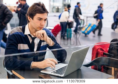Freelancer working with a laptop in train station