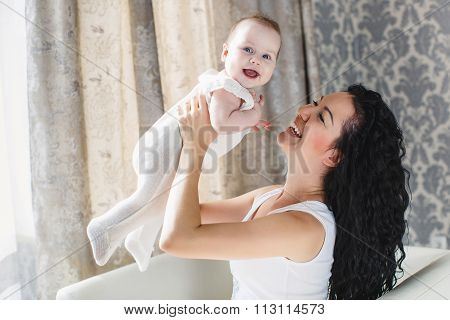 Portrait of happy mother and child in the home environment