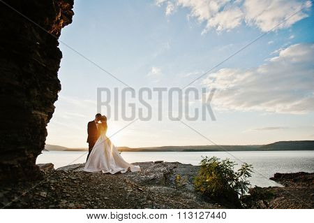 Very Sensual And Gorgeus Wedding Couple On The Picturesque Landscapes On Sunset