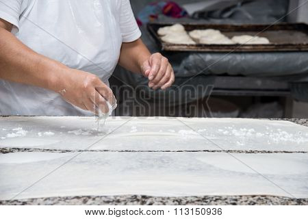 Close Up Of Female Hands Kneading Dough And Making Banitsa