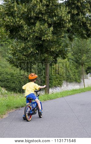 Child Cycling On A Path