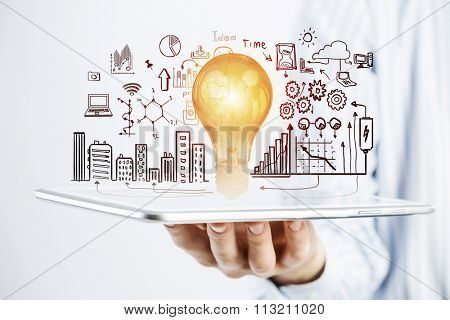 Hands of businessman demostrating tablet and construction concept on screen