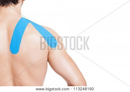 Muscular man with kinesiotaping on the shoulder, isolated on white background