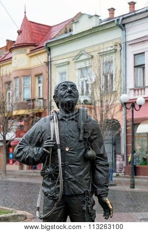 Mukachevo Ukraine - April 6 2015: Monument of Happy Chimney Sweeper and his cat. The monument with real chimney sweeper Bertalon Tovt by Ukrainian sculptor Ivan Brovdi