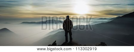 Man Watching Mountains Clouds From A Peak