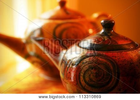 colored tea pot on yellow background. teapot