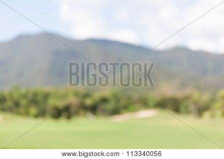 Abstract Blurred Background Of Green Golf Course.