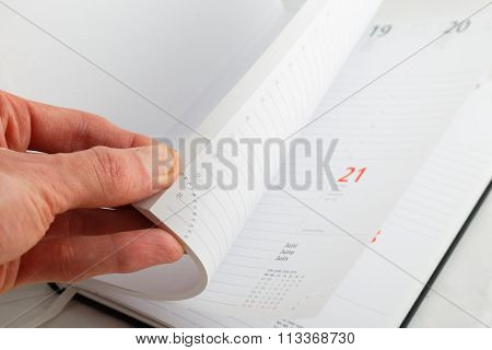 Man's Hand Turning The Pages Of The Diary