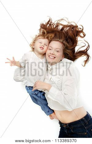 Girl lying oback with the baby cuddling