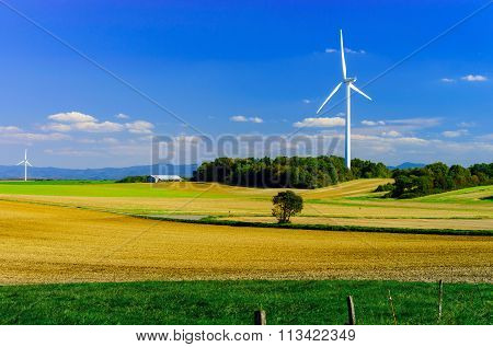 Wind Turbines Generating Electricity In Windfarm