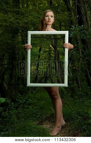 Lady Nature - Beoutiful Young Wman Stands In Nature With A Frame That Makes Her Transparent And Stre