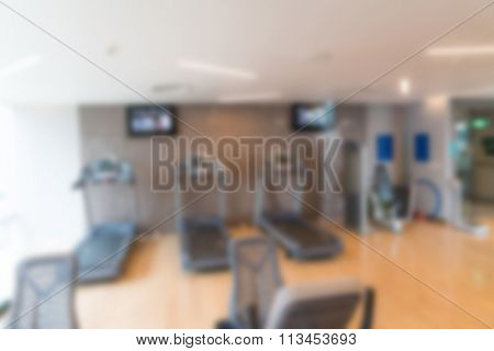 Abstract blur Fitness center with traineger equipments