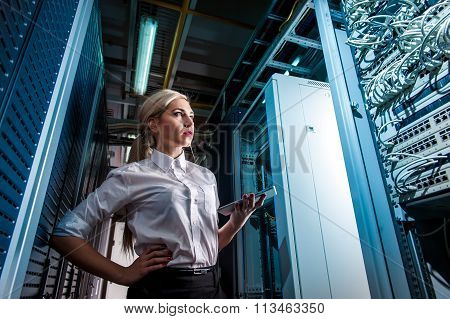 Young engineer businesswoman in server room