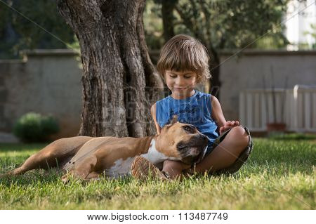 Little Boy Cuddling His Dog