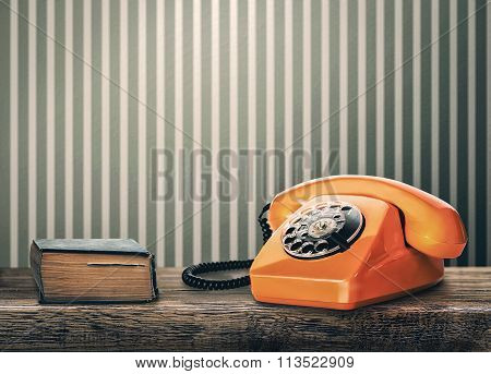 Vintage Phone And Book On A Table