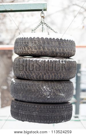 Boxing pear hanging made from the tires chained outdoors. Training and hardening fighting spirit in