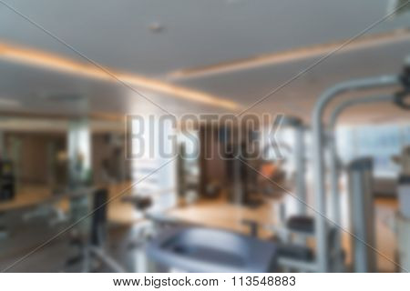Abstract blur Fitness center with traineger equipments