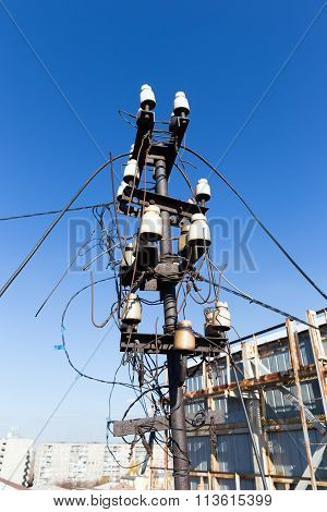 Interweaving street electrical wires on a background of blue sky