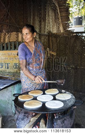 Indian woman cooking in her restaurant