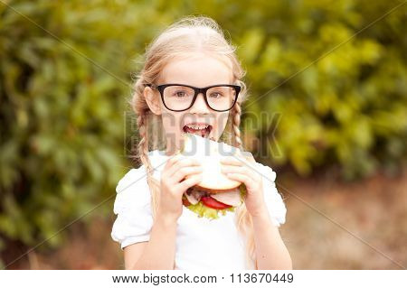 Girl biting sandwich