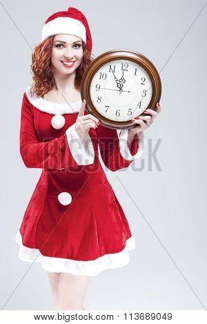 Time And Christmas Holiday Concept. Smiling And Gleeful Red-haired Santa Helper Showing Time On Big
